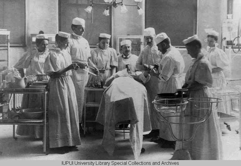 Historical photo of health care workers in surgery or lab.